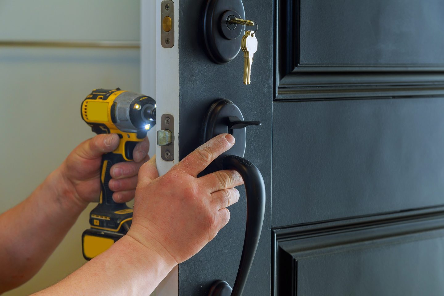 closeup-of-a-professional-locksmith-installing-a-new-lock-on-a-house-exterior-door-with-the-inside-e1696769086563.jpg